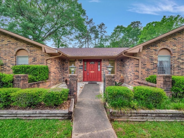 entrance to property featuring brick siding