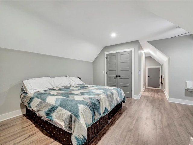 387 Cc Rd, Diboll, TX 75941 - bedroom with baseboards, wood finished floors, lofted ceiling, a closet, and recessed lighting