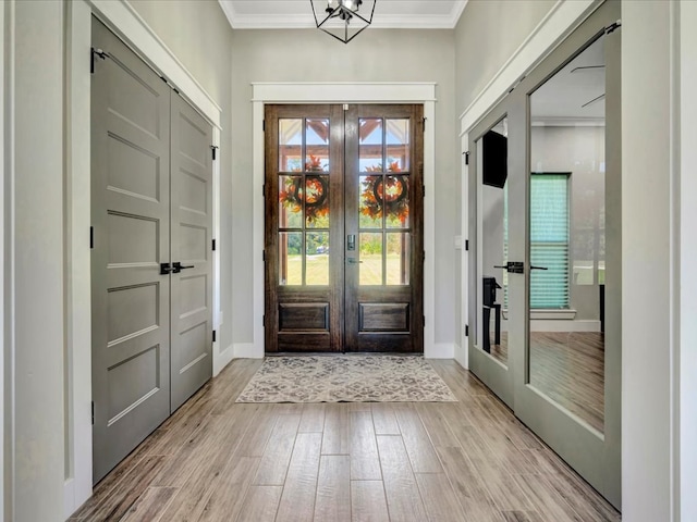 387 Cc Rd, Diboll, TX 75941 - entrance foyer featuring french doors, light wood finished floors, crown molding, and baseboards