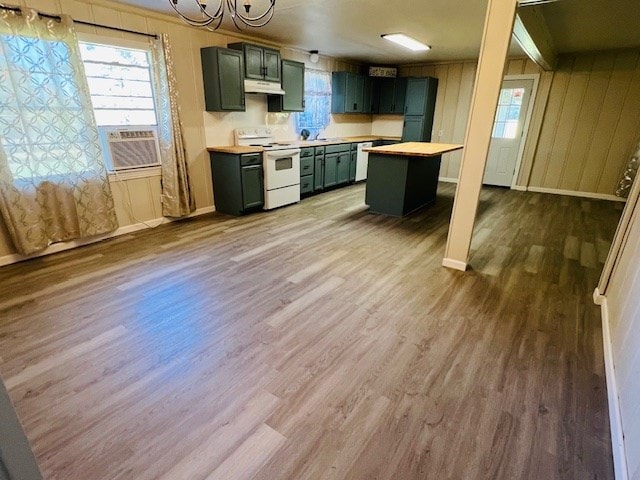 kitchen featuring a kitchen island, cooling unit, wood-type flooring, and white range with electric stovetop