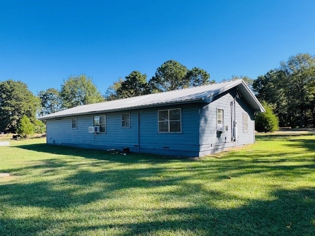 view of side of property with a yard and cooling unit