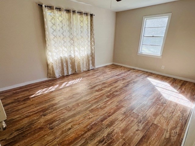 empty room with wood-type flooring and ceiling fan