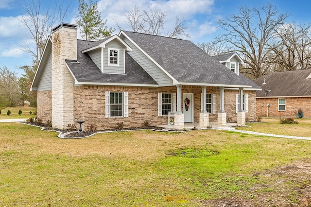 cape cod house with a chimney, brick siding, a front lawn, and a shingled roof