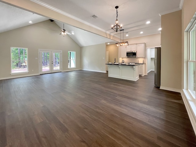 unfurnished living room with ceiling fan with notable chandelier, recessed lighting, baseboards, dark wood-type flooring, and visible vents