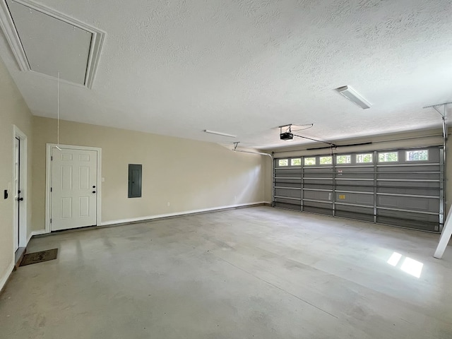 garage with baseboards, a garage door opener, and electric panel
