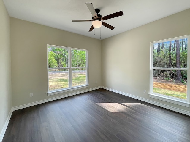 empty room with dark wood-style flooring, baseboards, and ceiling fan