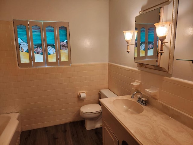 911 Allendale, Lufkin, TX 75904 - bathroom with wood finished floors, vanity, tile walls, and wainscoting