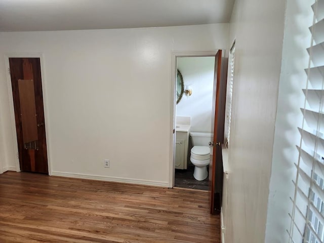 911 Allendale, Lufkin, TX 75904 - unfurnished bedroom featuring wood finished floors and ensuite bath