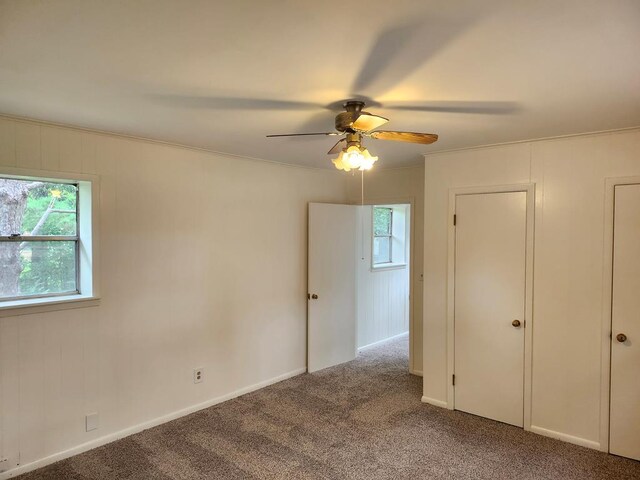 911 Allendale, Lufkin, TX 75904 - unfurnished bedroom featuring multiple windows, carpet flooring, a ceiling fan, and ornamental molding