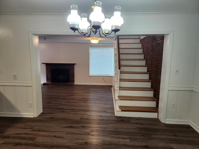 911 Allendale, Lufkin, TX 75904 - unfurnished dining area with a chandelier, dark wood-style flooring, stairway, a decorative wall, and ornamental molding