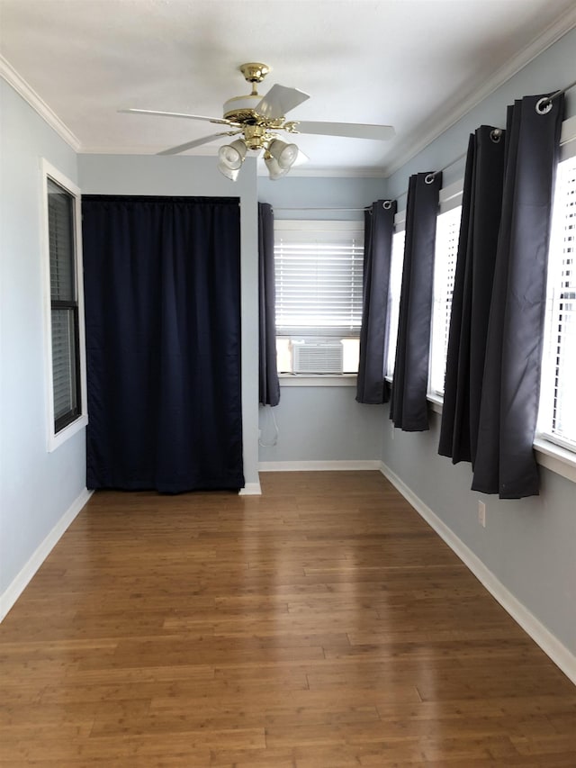 unfurnished room with hardwood / wood-style flooring, cooling unit, and ornamental molding