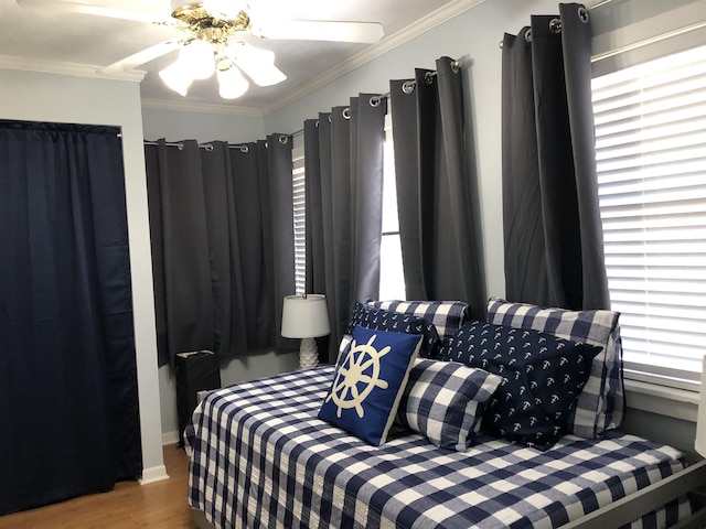 bedroom with multiple windows, ceiling fan, and ornamental molding