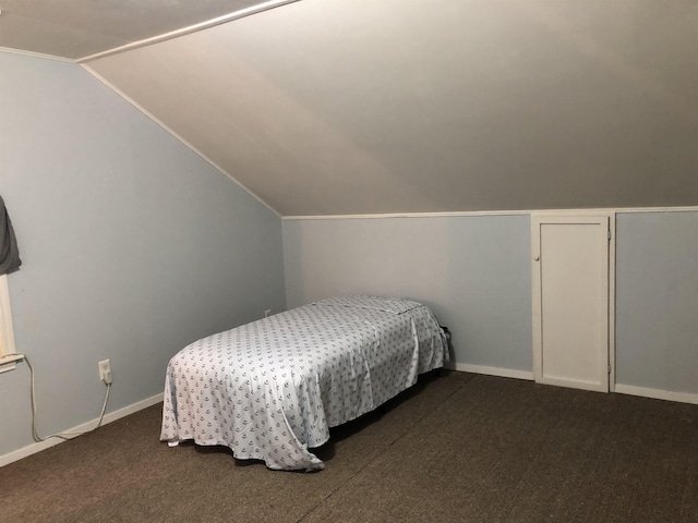 carpeted bedroom featuring lofted ceiling