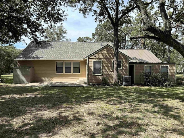 ranch-style house with cooling unit, a patio area, and a front lawn