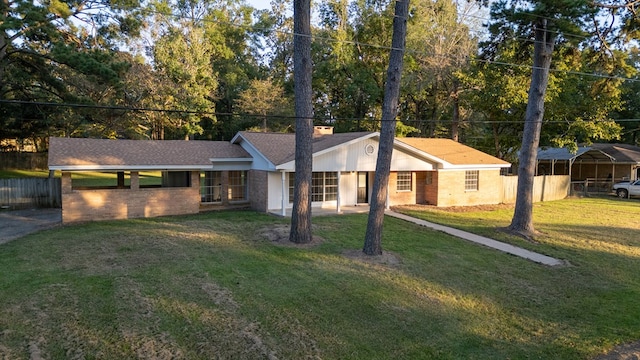 ranch-style home with a front lawn