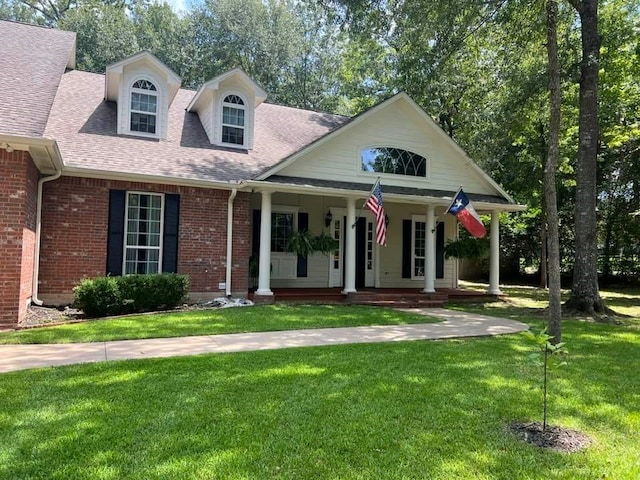 102 Harmony Hill Ct, Lufkin, TX 75901 - view of front facade with a front yard, a porch, a shingled roof, and brick siding