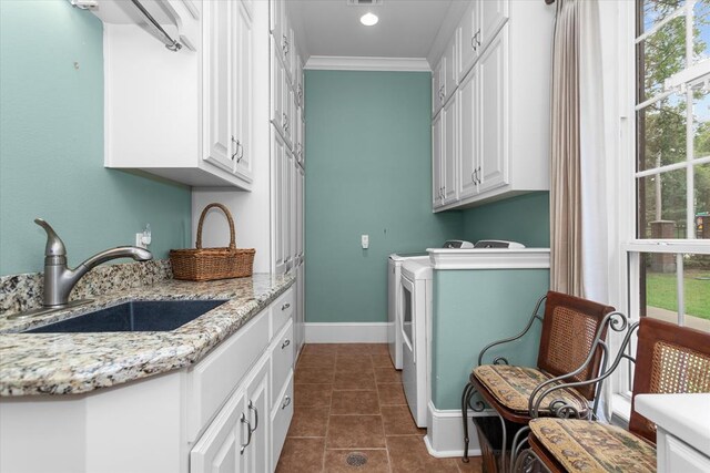 102 Harmony Hill Ct, Lufkin, TX 75901 - laundry area featuring cabinet space, washer and clothes dryer, ornamental molding, dark tile patterned flooring, and baseboards