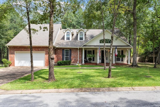 102 Harmony Hill Ct, Lufkin, TX 75901 - cape cod house with driveway, covered porch, brick siding, and a front lawn