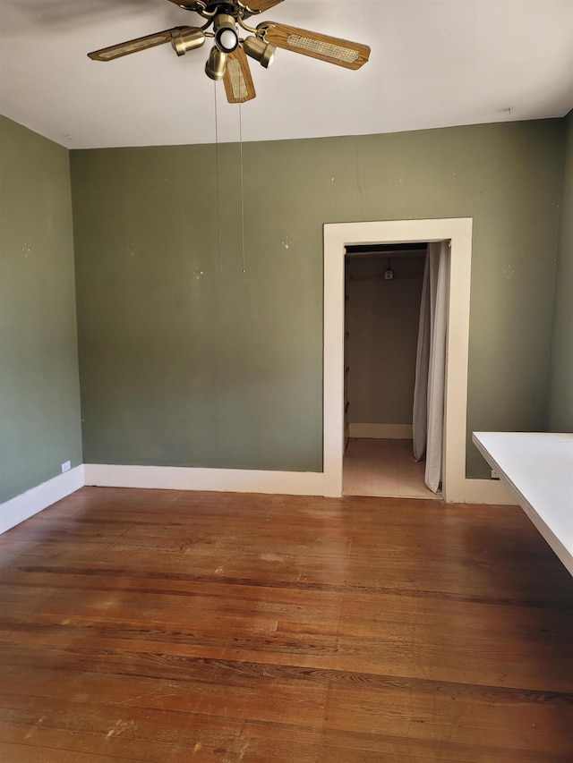 spare room with ceiling fan and hardwood / wood-style floors