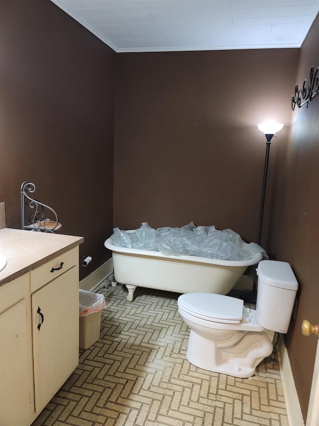 bathroom with vanity, toilet, and crown molding