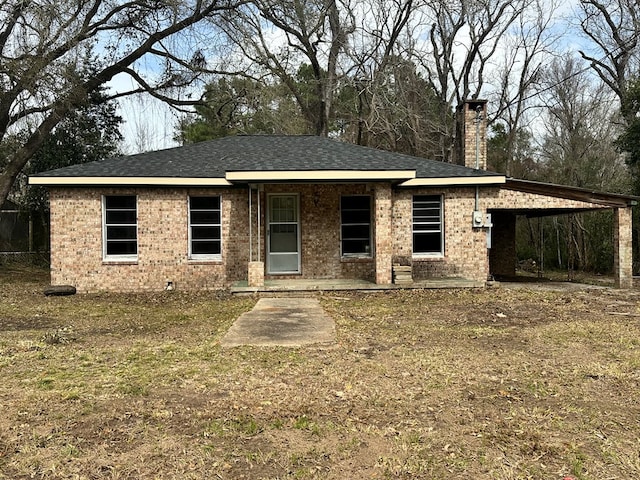 view of front of home with brick siding and a chimney