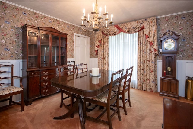 dining area with light colored carpet, crown molding, and an inviting chandelier