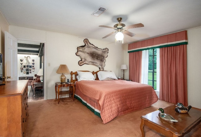 bedroom with ceiling fan, ornamental molding, light carpet, and access to outside