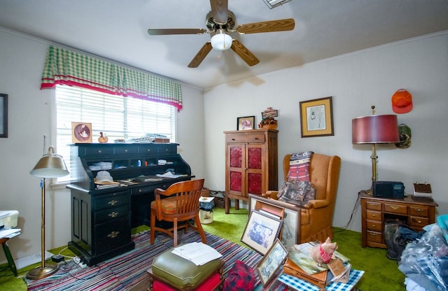 home office with carpet flooring, ceiling fan, and ornamental molding