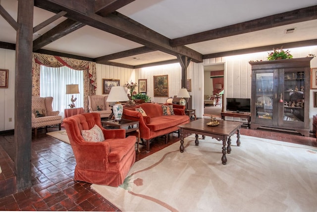 living room featuring beamed ceiling