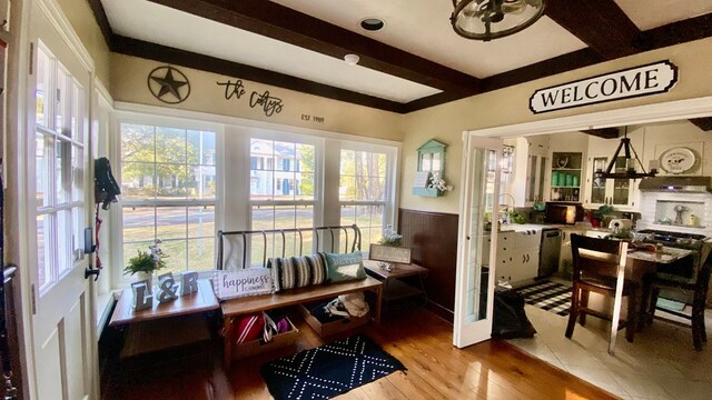661 N Bowie St, Jasper, TX 75951 - sunroom / solarium with beamed ceiling, healthy amount of natural light, a wainscoted wall, and wood finished floors