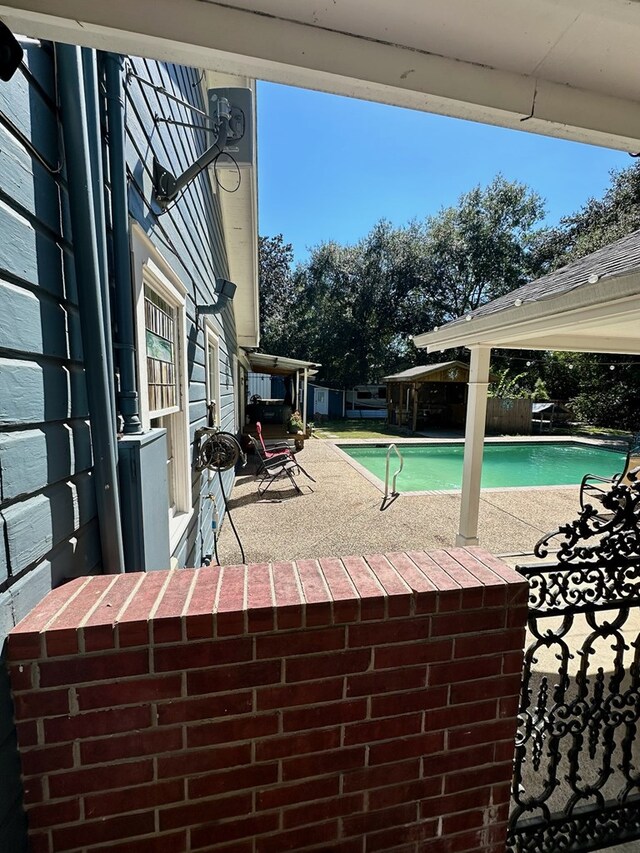 view of swimming pool with a patio area