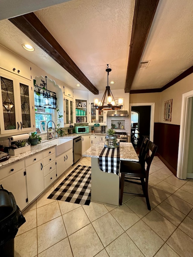 661 N Bowie St, Jasper, TX 75951 - dining room featuring a textured ceiling, beam ceiling, a chandelier, light tile patterned floors, and plenty of natural light