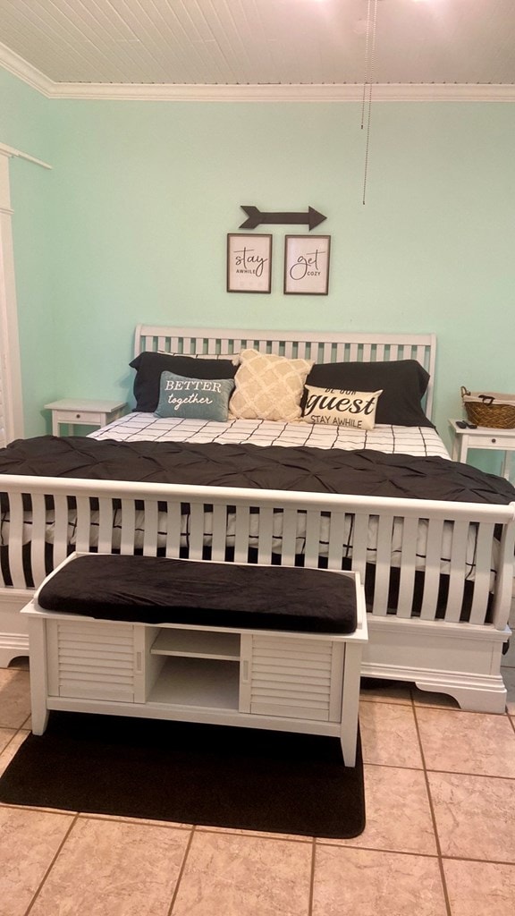 tiled bedroom featuring ornamental molding