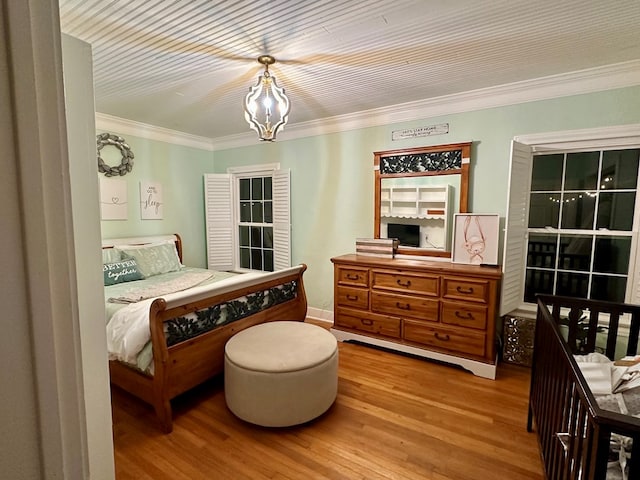 bedroom with hardwood / wood-style flooring and crown molding