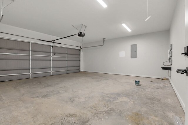 garage with electric panel and a garage door opener