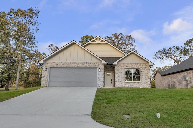 view of front of home with a garage, central air condition unit, and a front yard