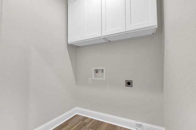 laundry room with cabinets, hookup for a washing machine, hardwood / wood-style floors, and hookup for an electric dryer