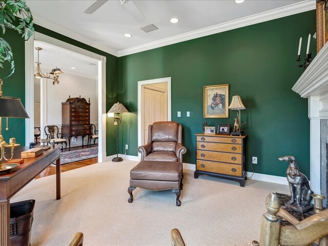 sitting room with hardwood / wood-style flooring, ceiling fan, and crown molding