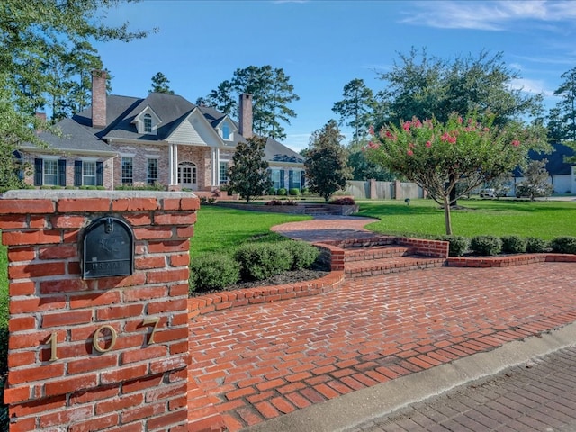 view of home's community with a lawn