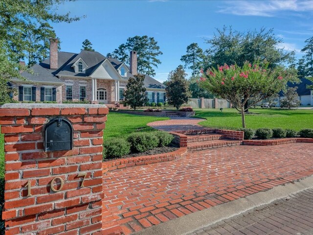 view of home's community with a lawn