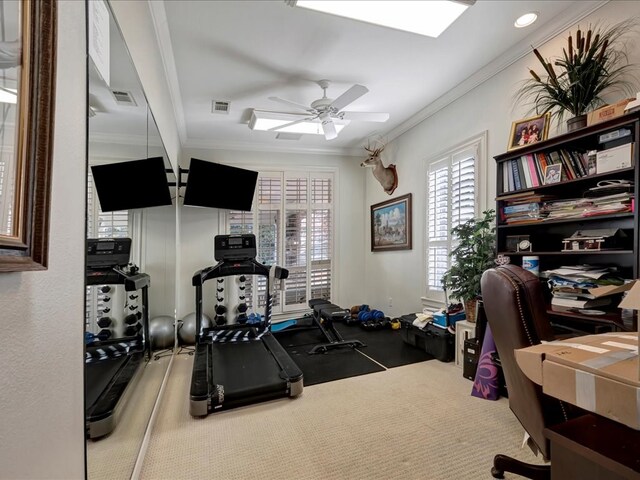 exercise room with ceiling fan and crown molding