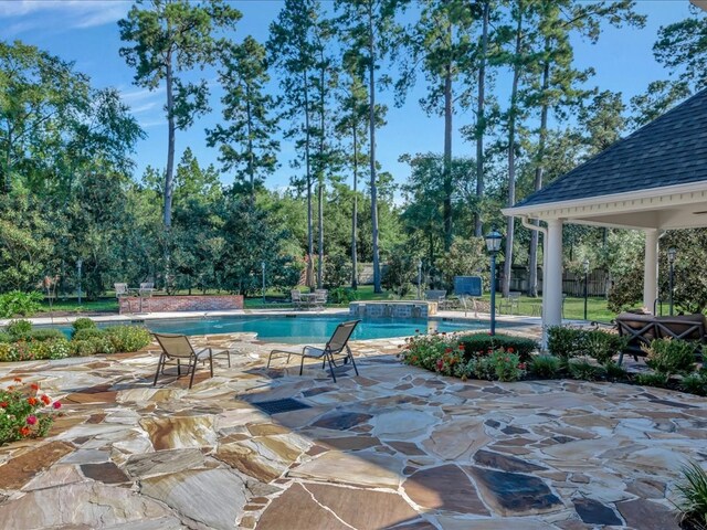 view of patio with a pool with hot tub