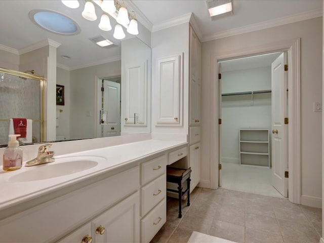 bathroom with tile patterned flooring, vanity, walk in shower, and ornamental molding