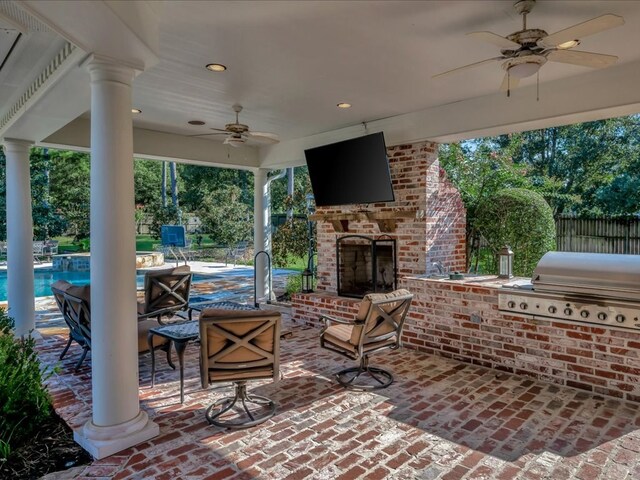 view of patio featuring an outdoor brick fireplace, a grill, ceiling fan, and an outdoor kitchen