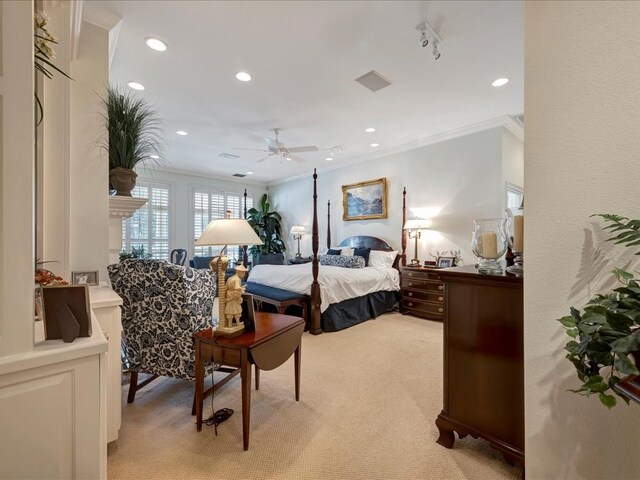 carpeted bedroom with ceiling fan and crown molding