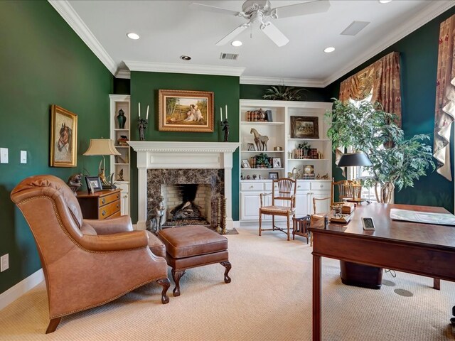 sitting room with a premium fireplace, ceiling fan, light carpet, and ornamental molding