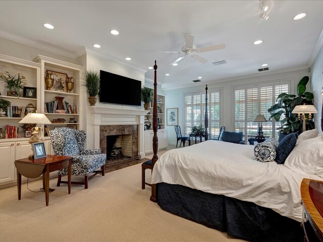 carpeted bedroom featuring a fireplace, ceiling fan, and crown molding