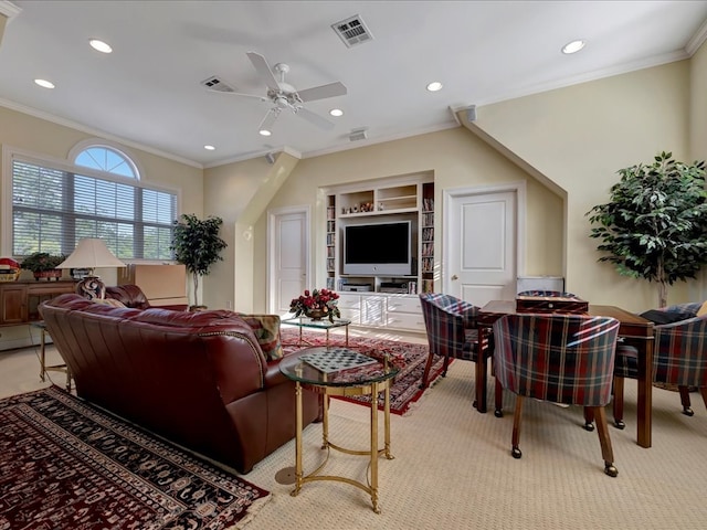 carpeted living room with ceiling fan, ornamental molding, and built in shelves