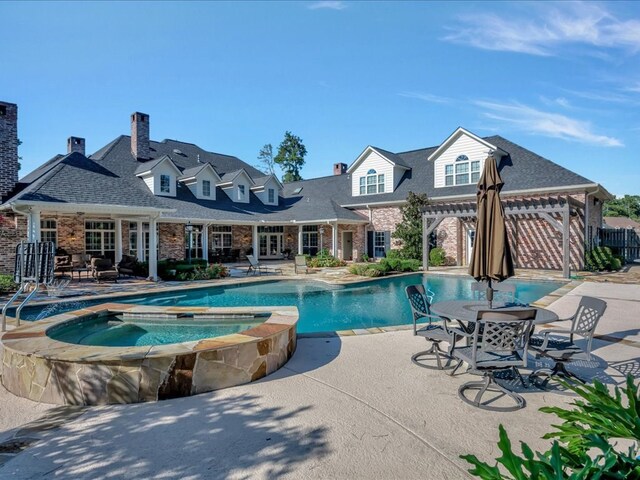 view of pool featuring a patio area, a pergola, and an in ground hot tub