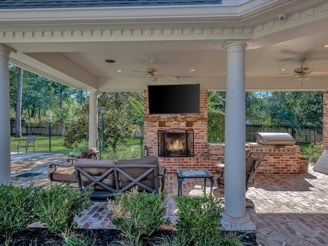 view of patio with an outdoor kitchen, an outdoor brick fireplace, ceiling fan, and a grill